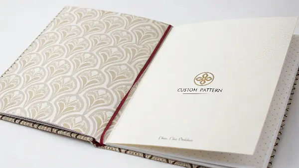 A notebook opened to show a custom-designed patterned endpaper.