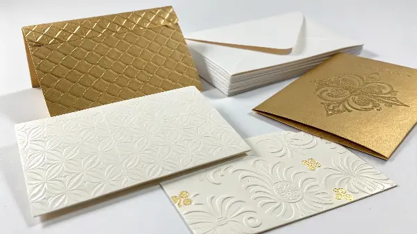 A person's finger tracing over an embossed logo on a high-quality journal.
