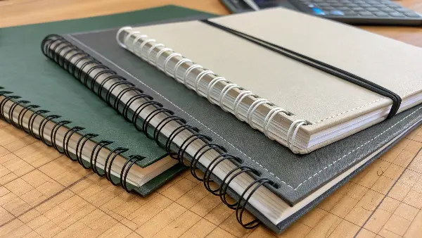 A close-up shot of a well-constructed perfect-bound notebook spine showing its strength and flexibility.