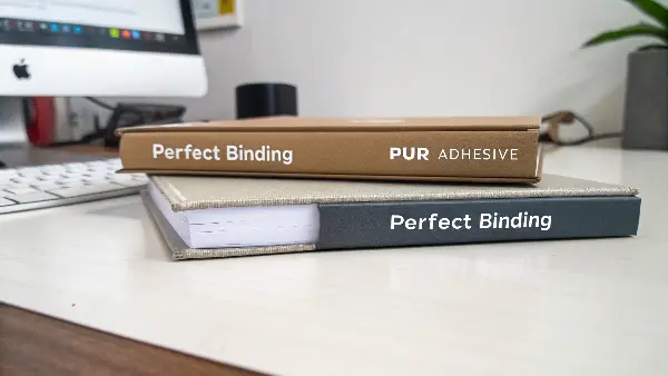 An illustration showing the perfect binding process with a glue roller