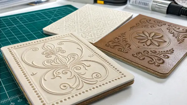 An illustration comparing the side-profile of an embossed and debossed paper.