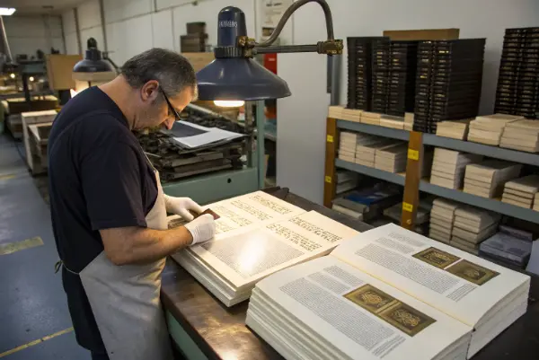 An assortment of material swatches including fine paper, leatherette, and ribbon markers.